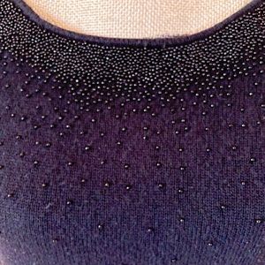 85% silk 15% cashmere Dry clean.  Great, soft sweater!